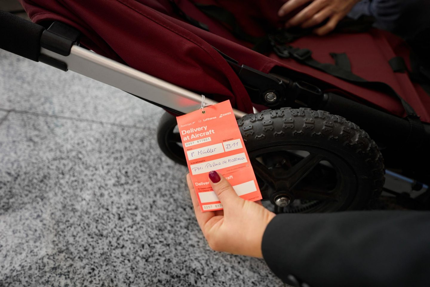 A tag being attached to a collapsible stroller