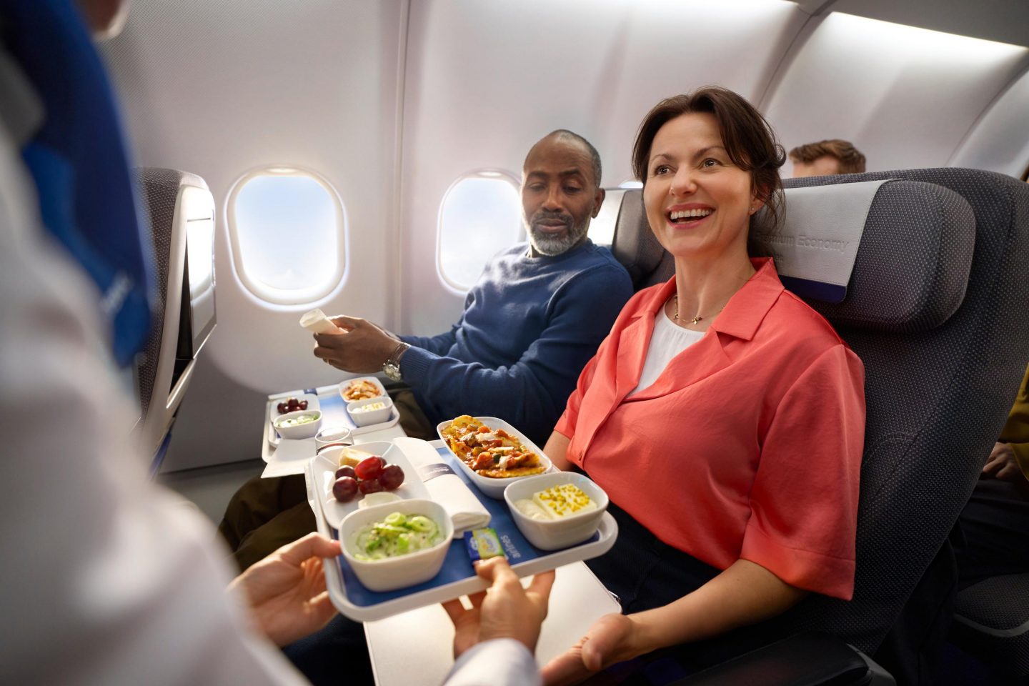 Premium Economy Class interkont Zwei Gästen wird das Essen in der Premium Economy Class gereicht