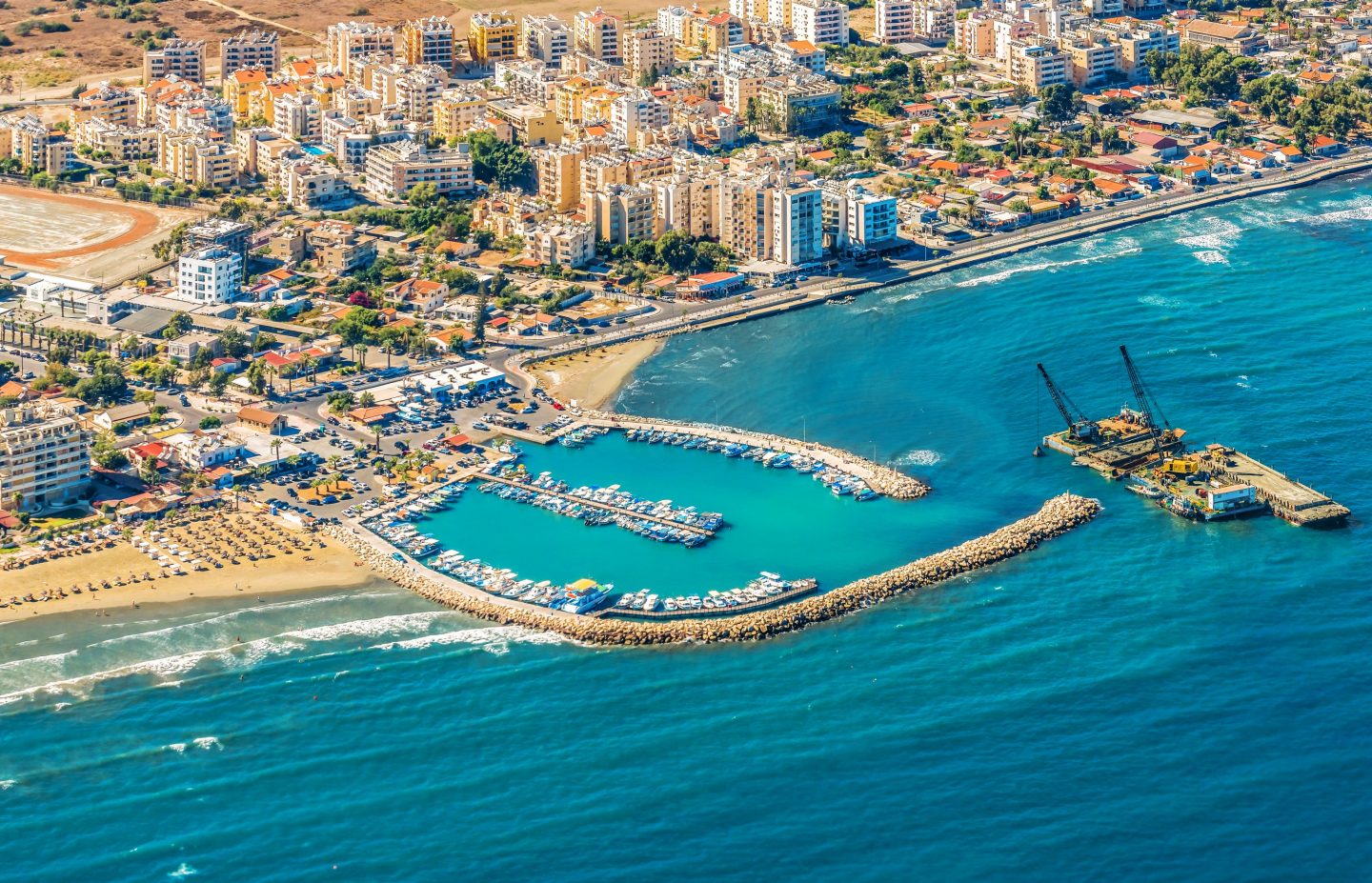 Sea port city of Larnaca, Cyprus. View from the aircraft to the coastline, beaches, seaport and the architecture of the city of Larnaca.