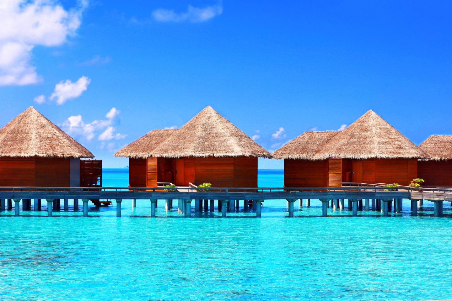 Wooden houses on stilts in the water in the Maldives