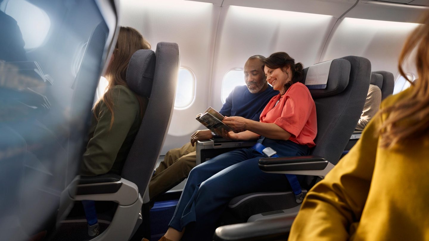 A couple sitting in Premium Economy Class