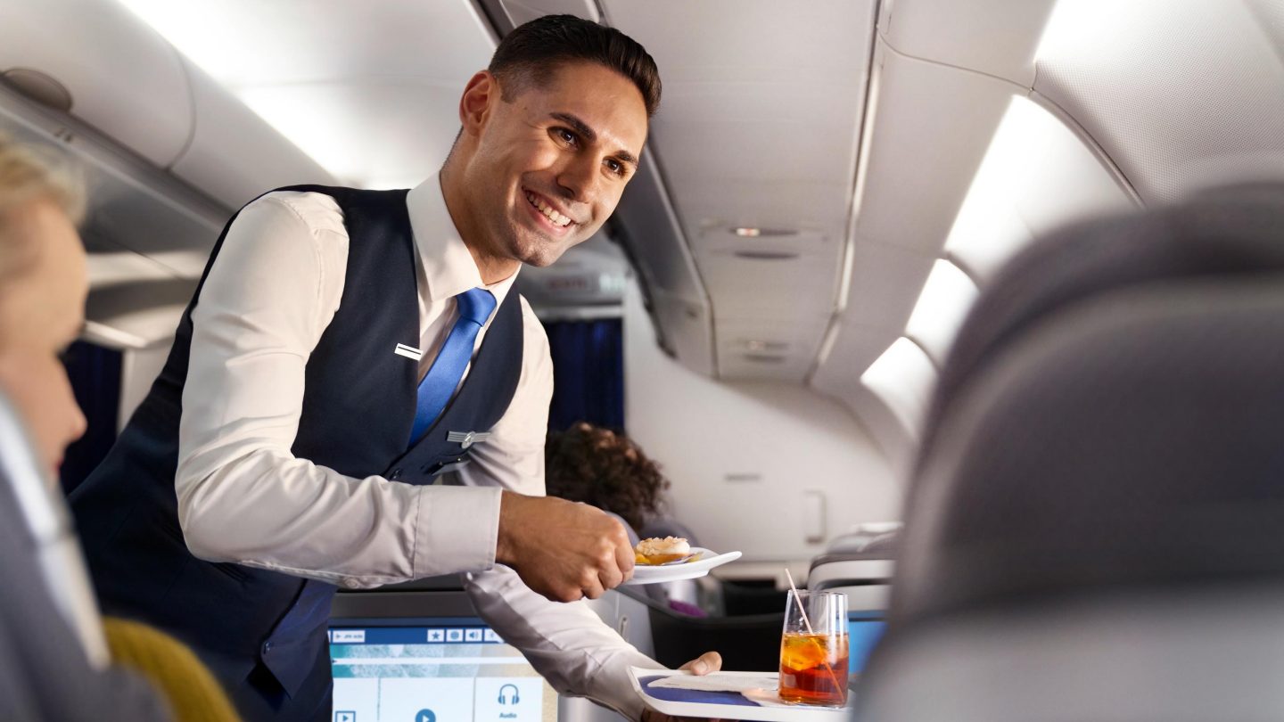 A cabin manager serves food