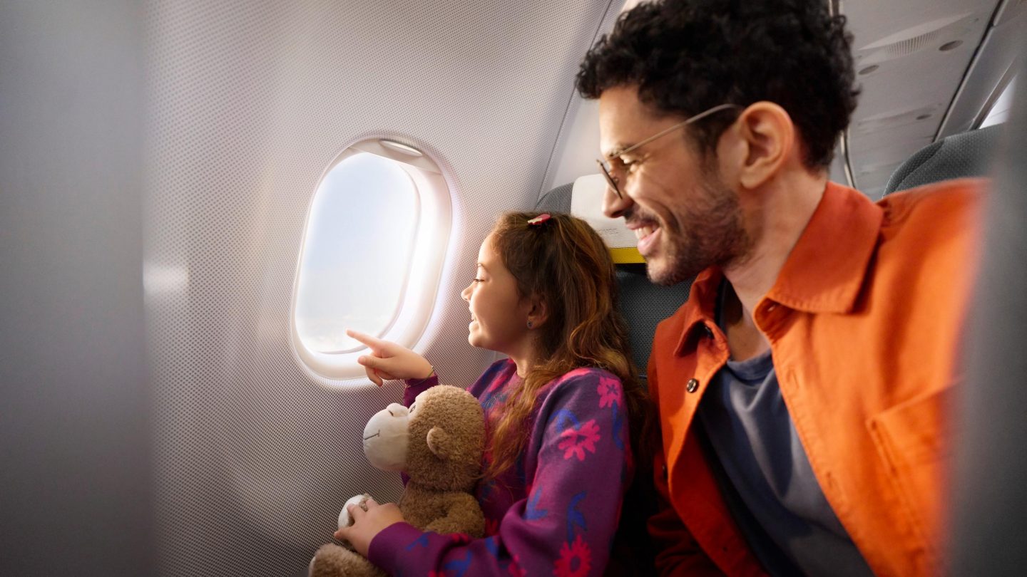 A child and her father in Economy Class