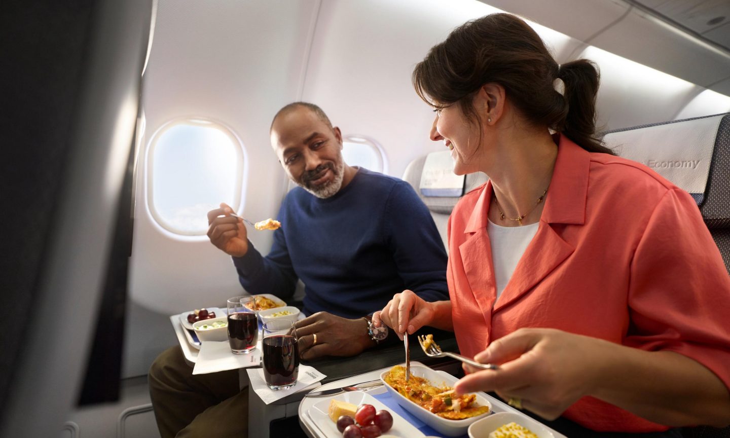 Premium Economy meal Two people eat a meal in Premium Economy Class