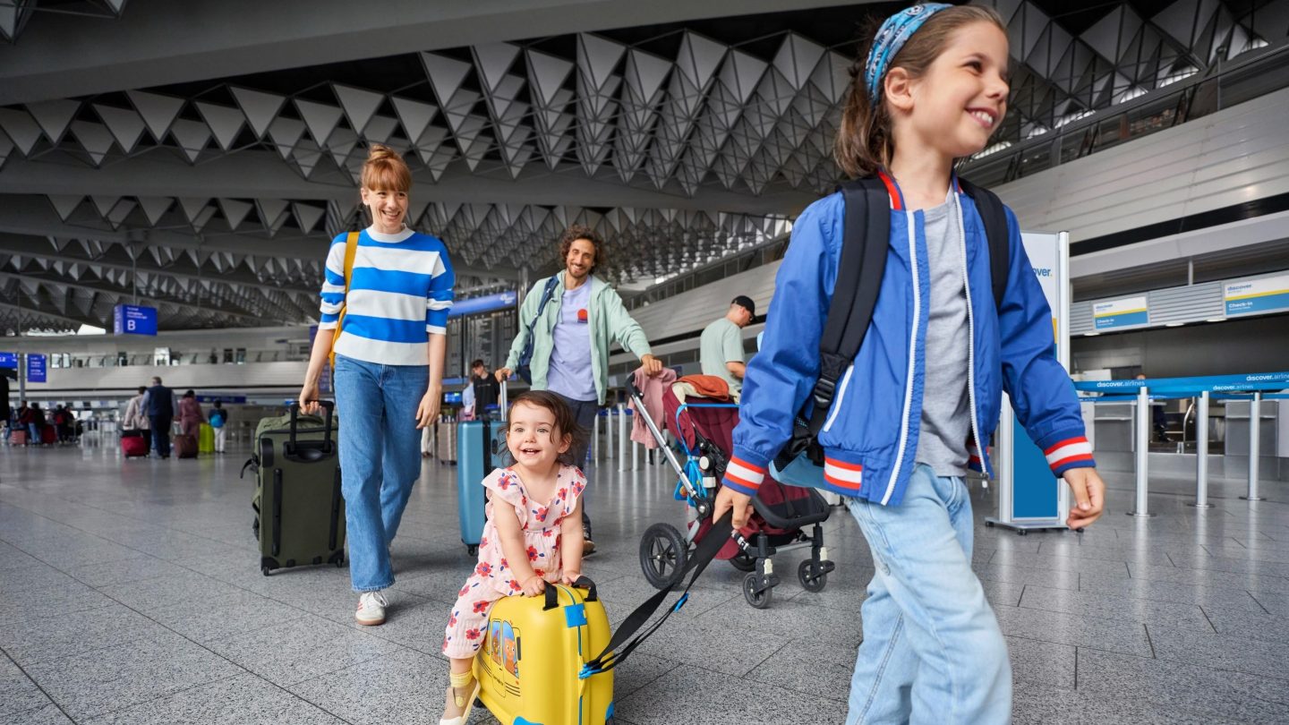 A family with small children in the departure hall at the airport