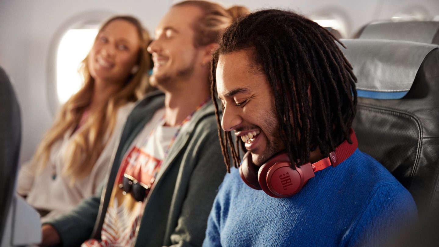 Three friends sitting in Economy Class