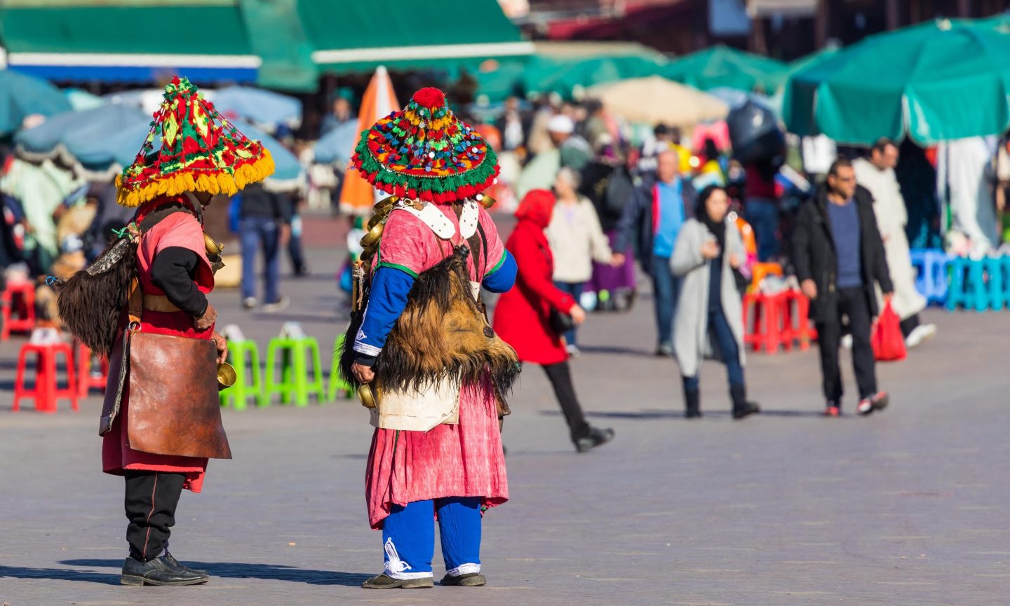 Traditionally dressed people in the Jemaa el-Fnaa market square in Marrakesh