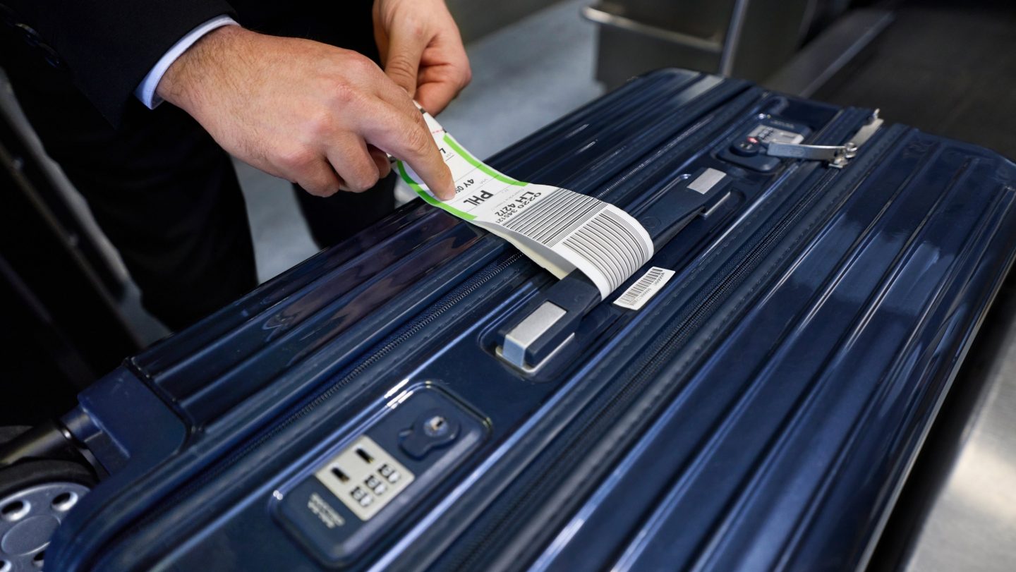 Baggage tag is attached to a suitcase