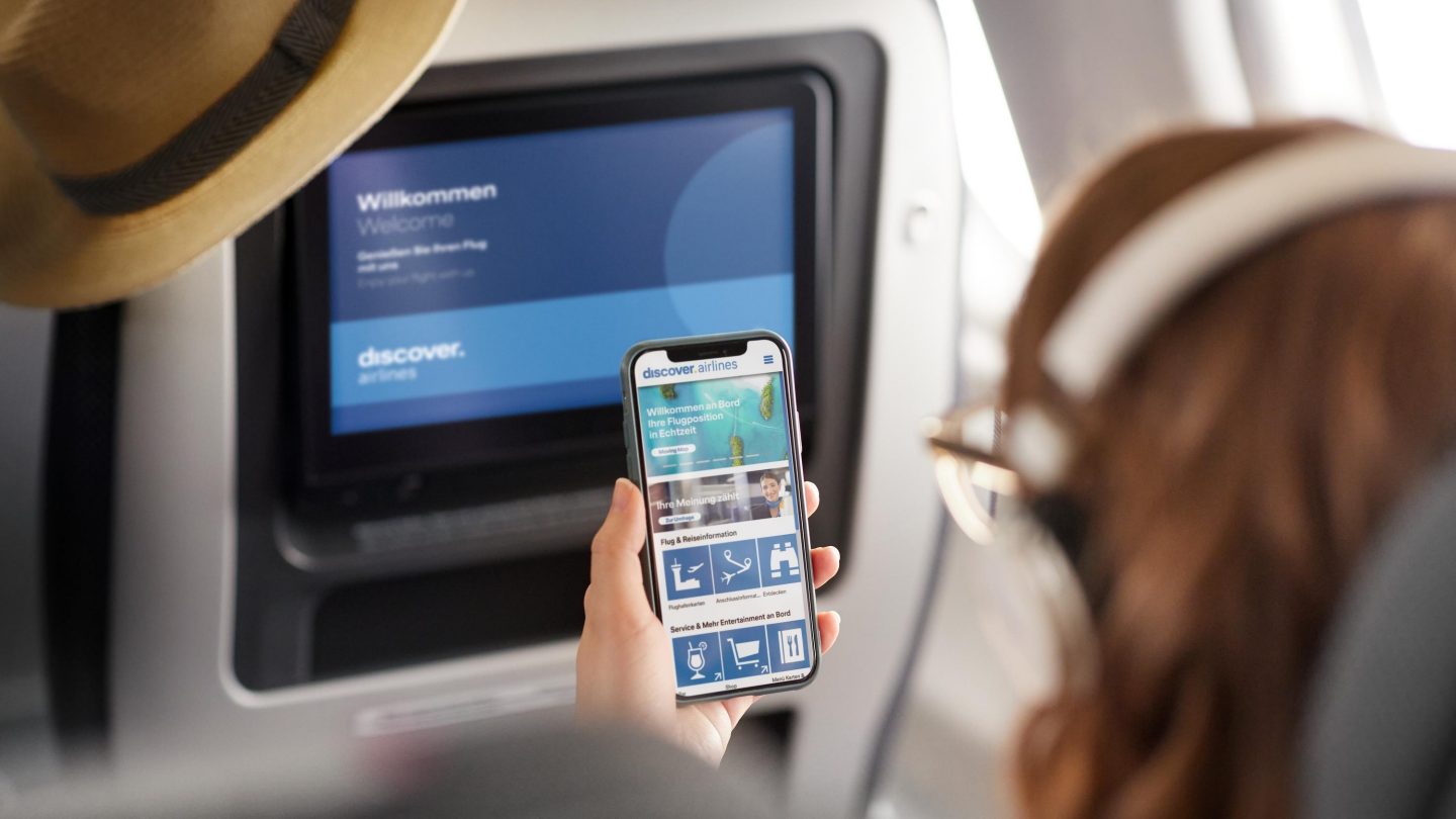 Passenger looking at the Onboard Cloud on their cell phone
