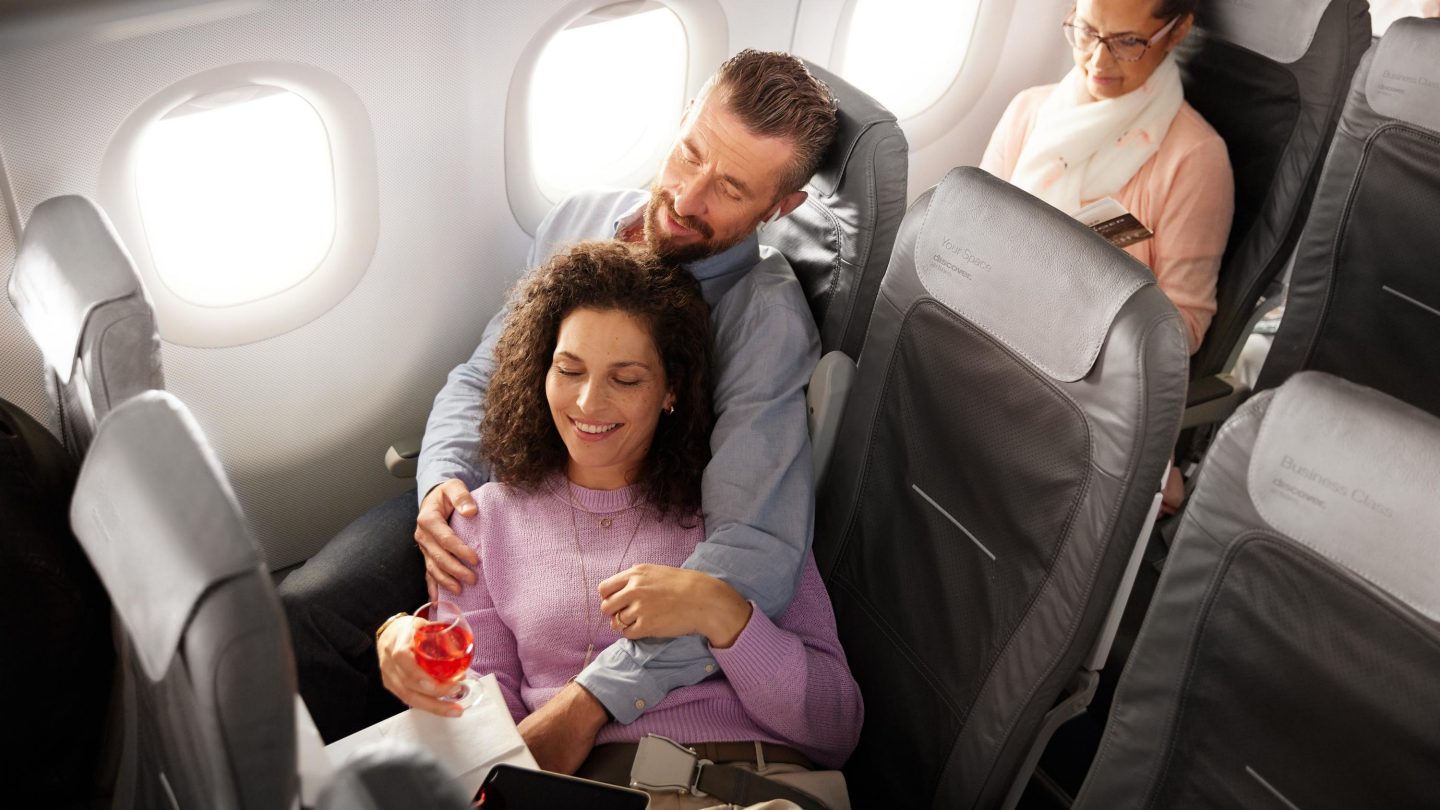 A couple sitting in Business Class in an A320 aircraft