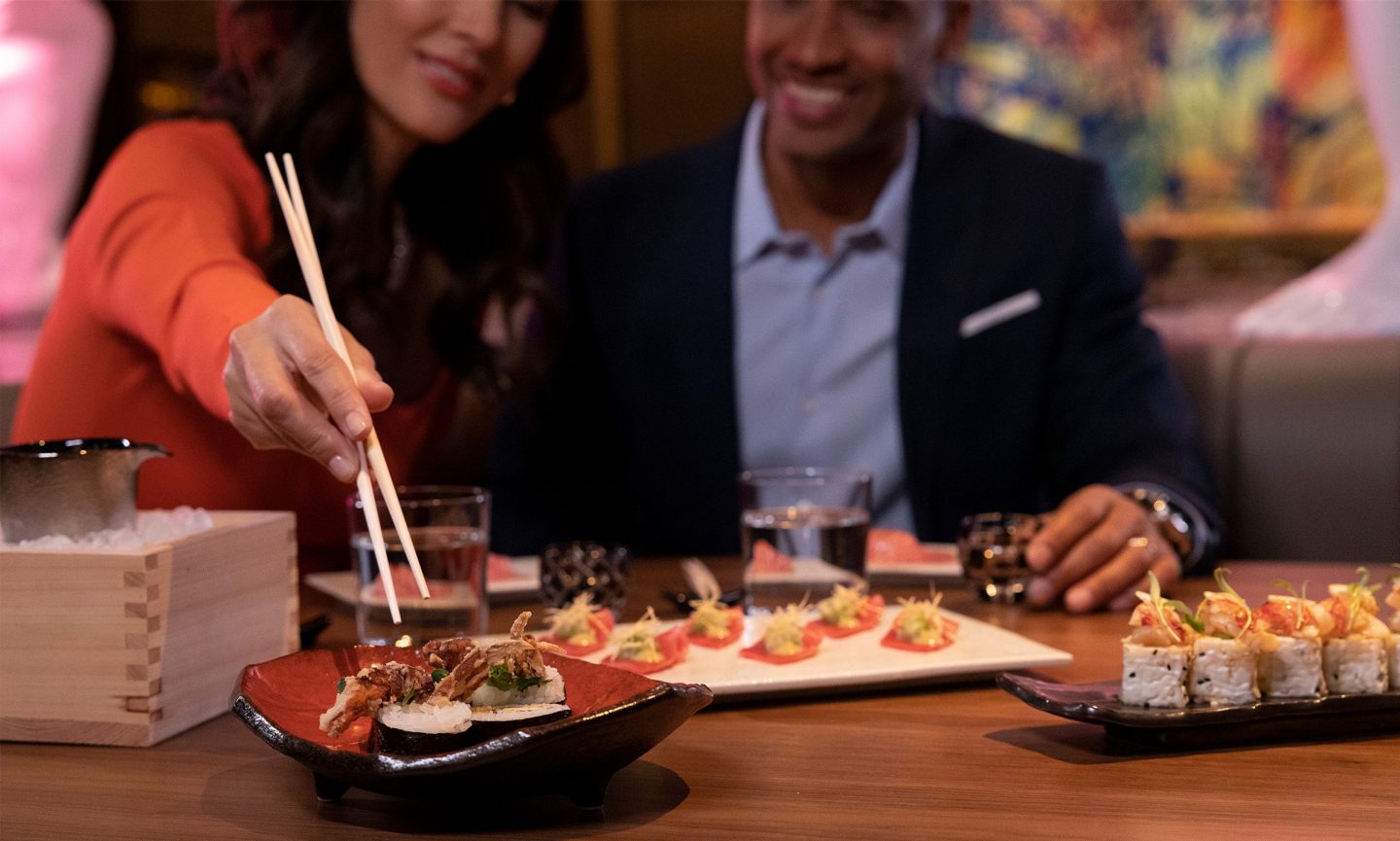 Two people eating sushi