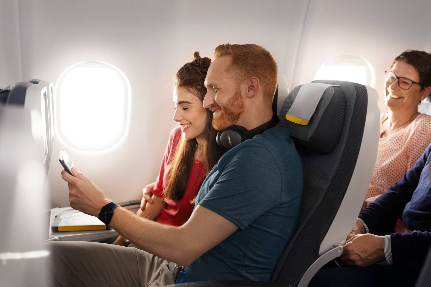 Couple looking at a tablet in Economy Class Longhaul
