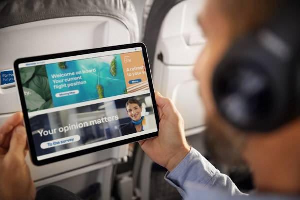 A man holds a tablet in his hand and looks at the Onboard Cloud