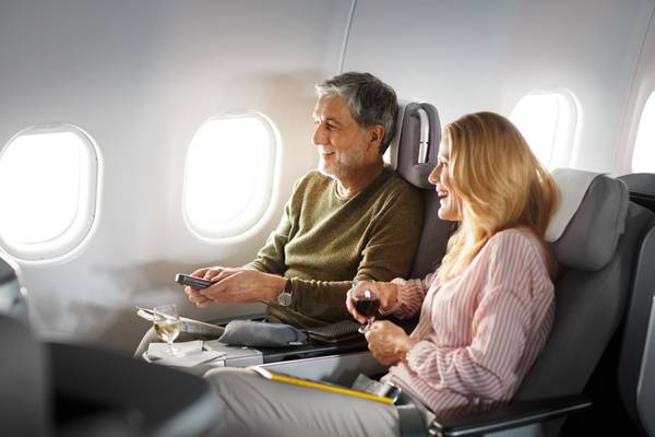Couple using the entertainment program and sitting in Business Class Longhaul